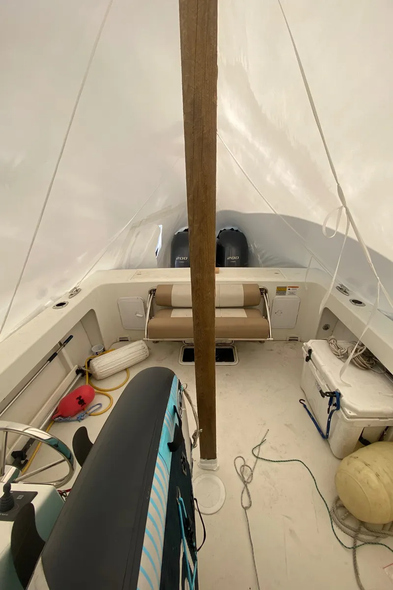 Slide: The Image of 2018 Parker 2530 Extended Cabin boat interior with covered seating and equipment. - 10