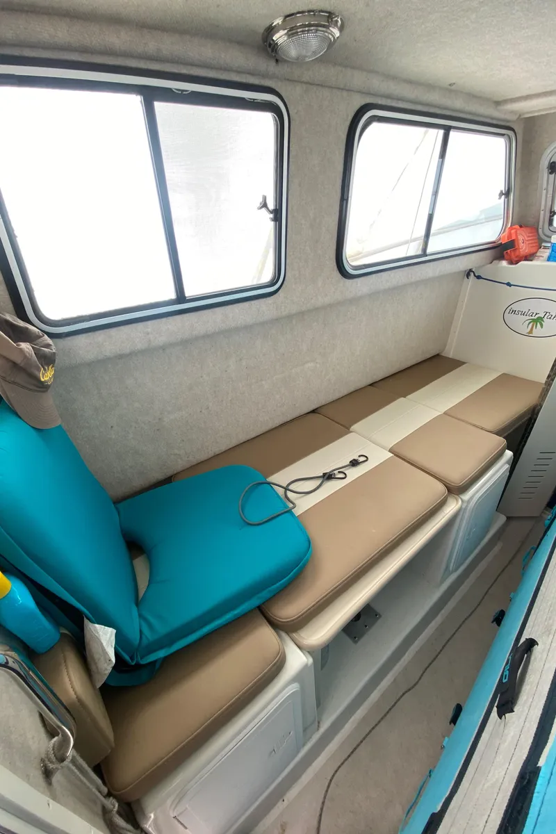 Slide: The Image of 2018 Parker 2530 Extended Cabin interior with cushioned seating and windows. - 11