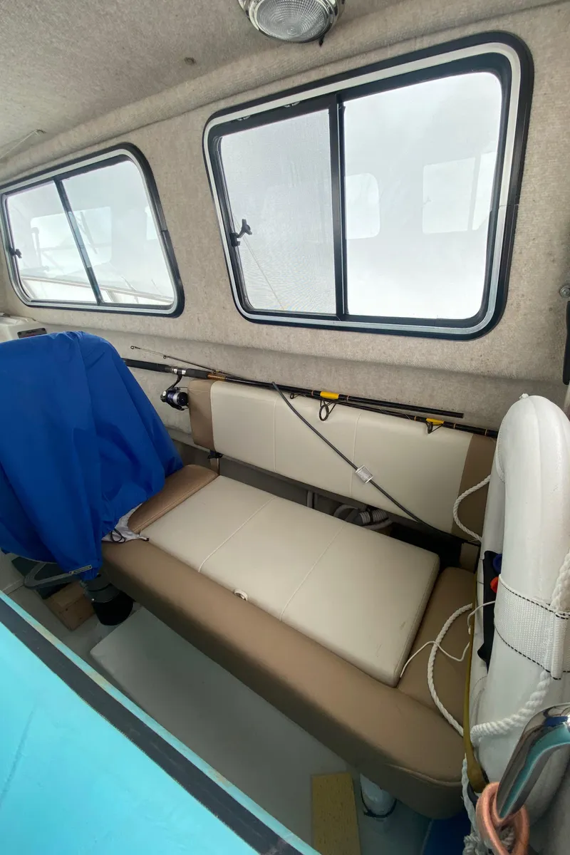 Slide: The Image of 2018 Parker 2530 Extended Cabin interior with seating and windows. - 12