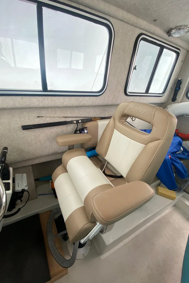 Slide: The Image of 2018 Parker 2530 Extended Cabin interior with beige seating and windows. - 14
