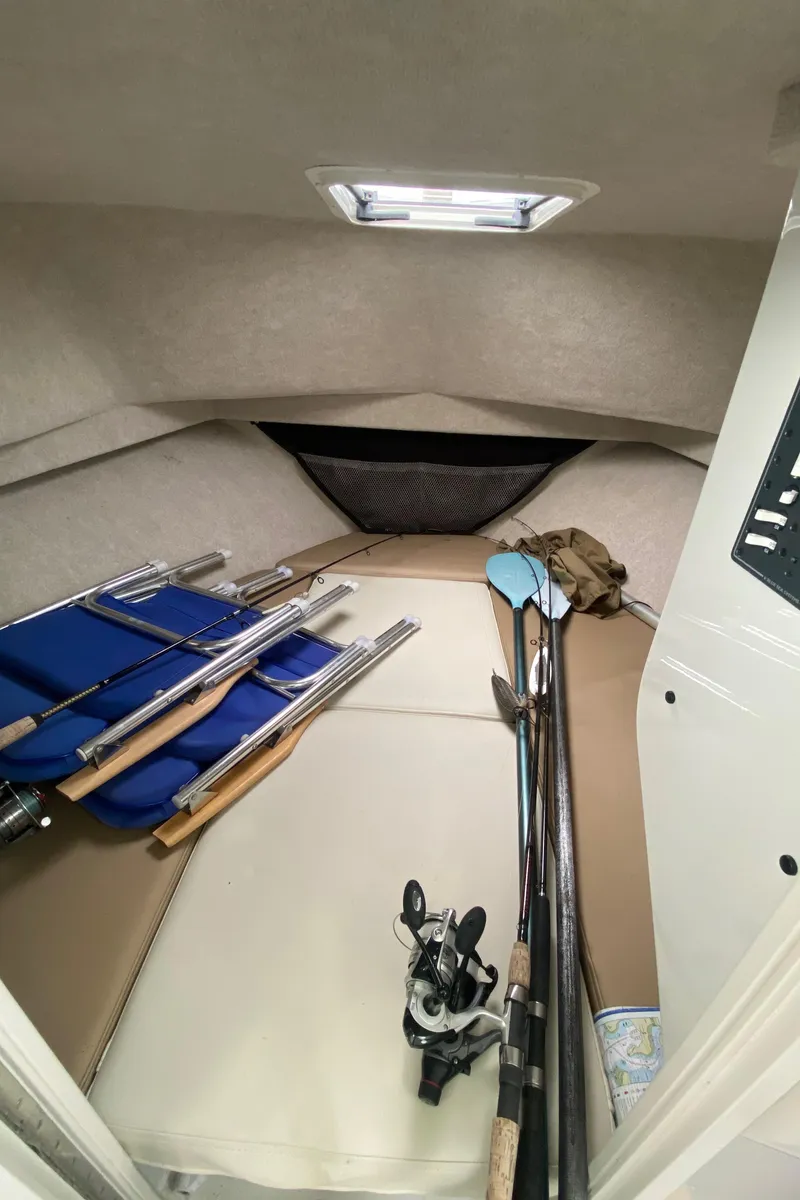 Slide: The Image of 2018 Parker 2530 Extended Cabin interior with fishing gear and rods. - 16