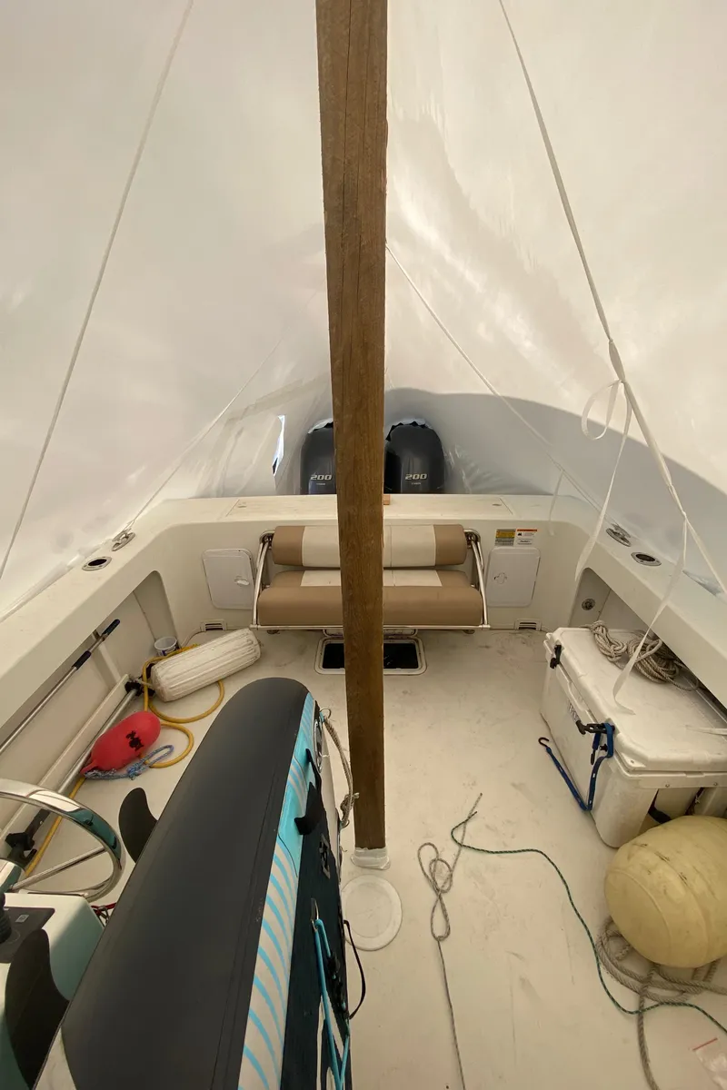 Slide: The Image of Interior of 2018 Parker 2530 Extended Cabin boat, featuring seating and storage. - 5