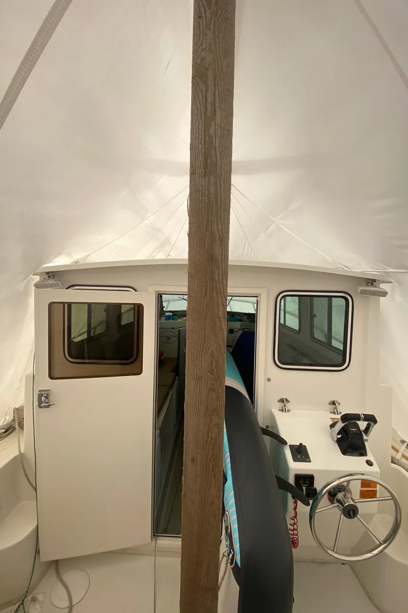 Slide: The Image of 2018 Parker 2530 Extended Cabin boat interior with steering wheel and controls. - 6