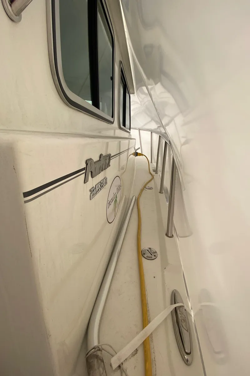 Slide: The Image of 2018 Parker 2530 Extended Cabin boat side view with railing and window. - 9