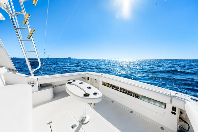 Slide: The Image of 2002 Pursuit 3800 Express boat deck with ocean view under clear blue sky. - 10