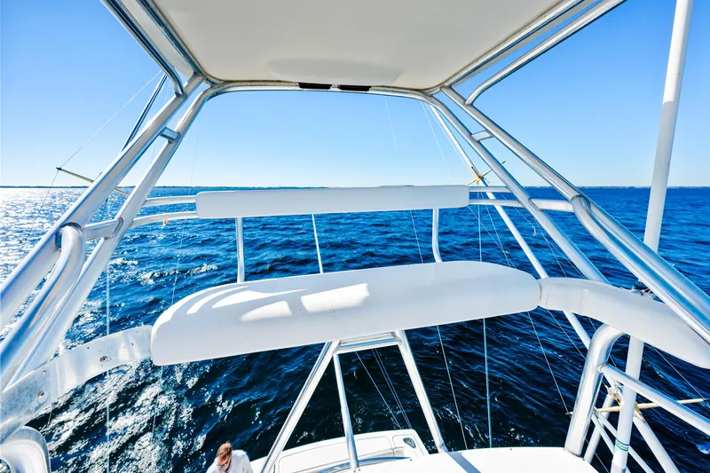 Slide: The Image of 2002 Pursuit 3800 Express boat on open sea, featuring sleek design and clear blue skies. - 13