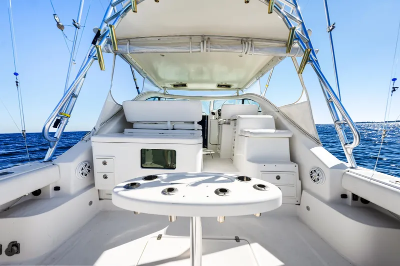 Slide: The Image of 2002 Pursuit 3800 Express yacht interior with fishing rod holders, ocean view. - 22