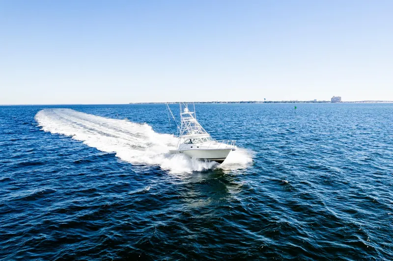 Slide: The Image of 2002 Pursuit 3800 Express boat cruising on open blue ocean waters. - 3