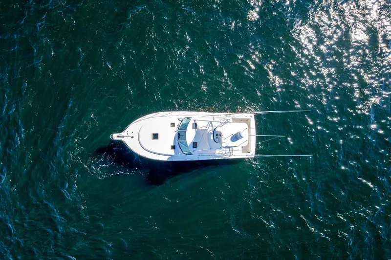Slide: The Image of Aerial view of 2002 Pursuit 3800 Express boat on open water. - 30