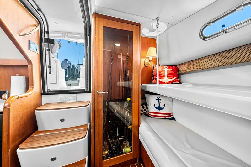 Slide: The Image of Interior of 2002 Pursuit 3800 Express boat with wooden steps and cozy seating. - 34