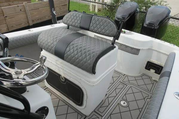 Slide: The Image of 2003 Yellowfin 23 Offshore boat interior with quilted seating and dual engines. - 18