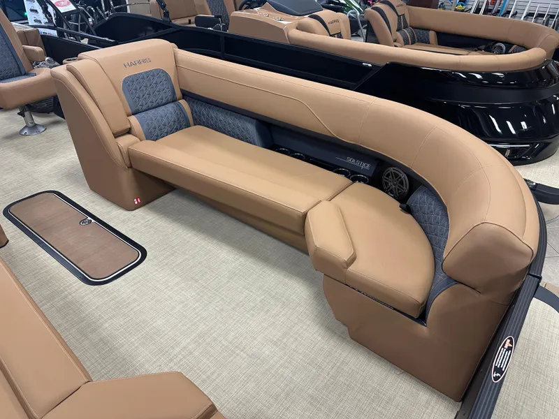 Slide: The Image of 2025 Harris Solstice 250 boat interior with tan and gray seating, showcasing luxury and comfort. - 3
