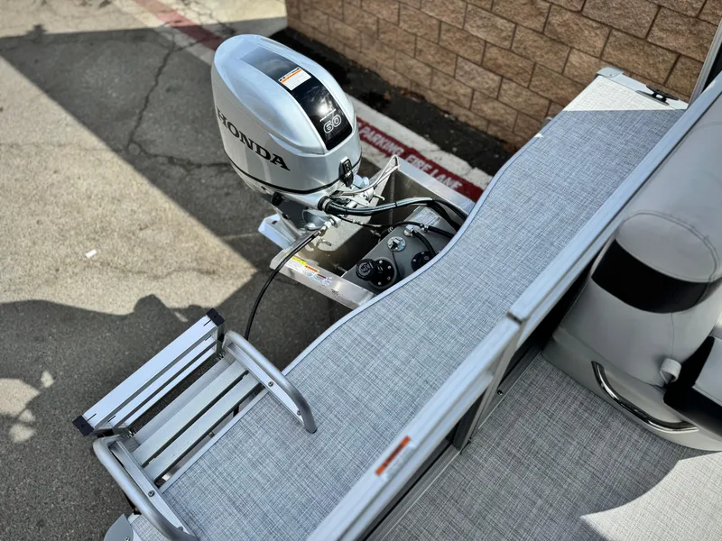 Slide: The Image of 2025 Berkshire 18 CR SE boat with Honda outboard motor and boarding ladder. - 12