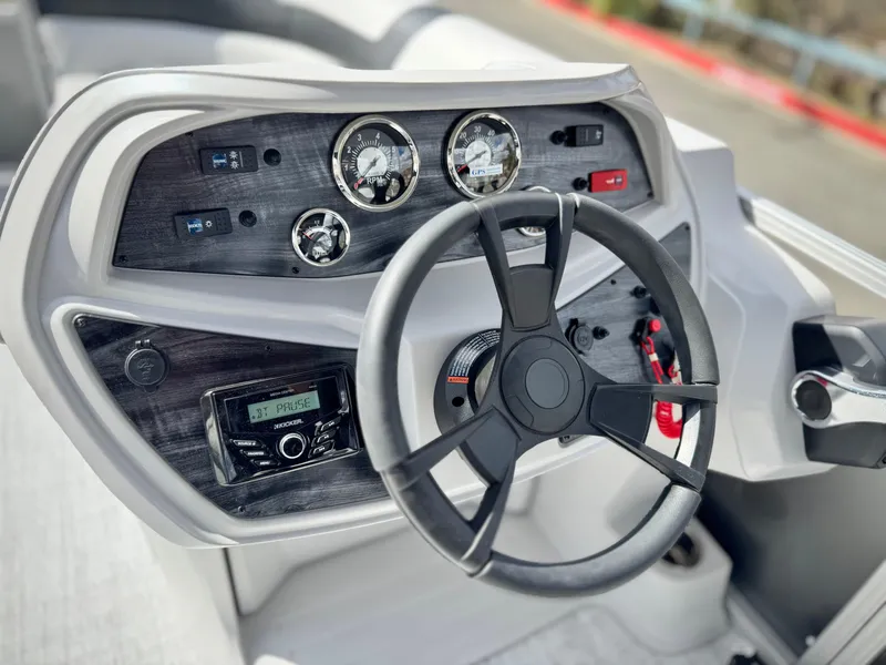 Slide: The Image of Steering console of 2025 Berkshire 18 CR SE boat with gauges and controls. - 16