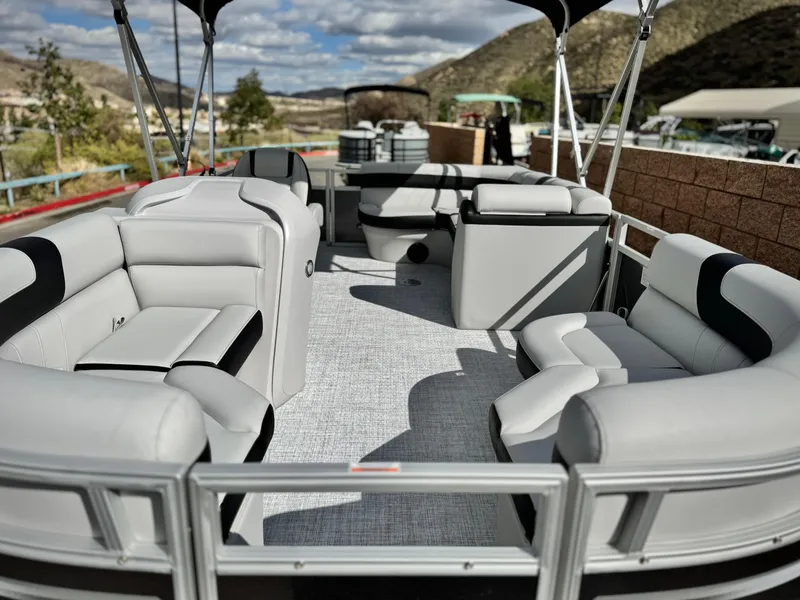 Slide: The Image of 2025 Berkshire 18 CR SE pontoon boat with spacious seating and scenic mountain backdrop. - 7