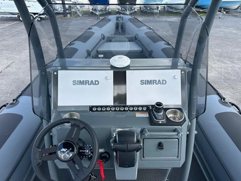 Slide: The Image of 2024 Highfield Patrol 860 boat dashboard with Simrad navigation system. - 16