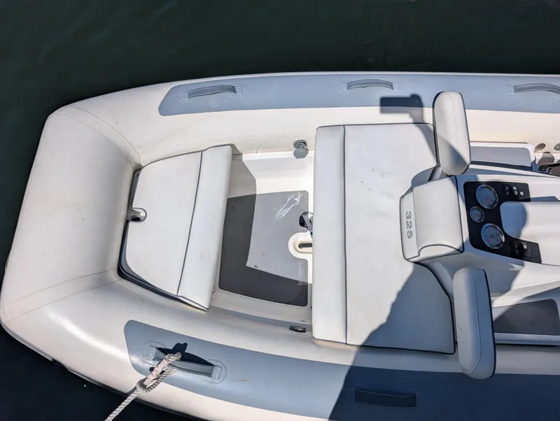 Slide: The Image of 2020 Williams Jet Tenders Turbojet 325, white interior, top view, docked on water. - 11