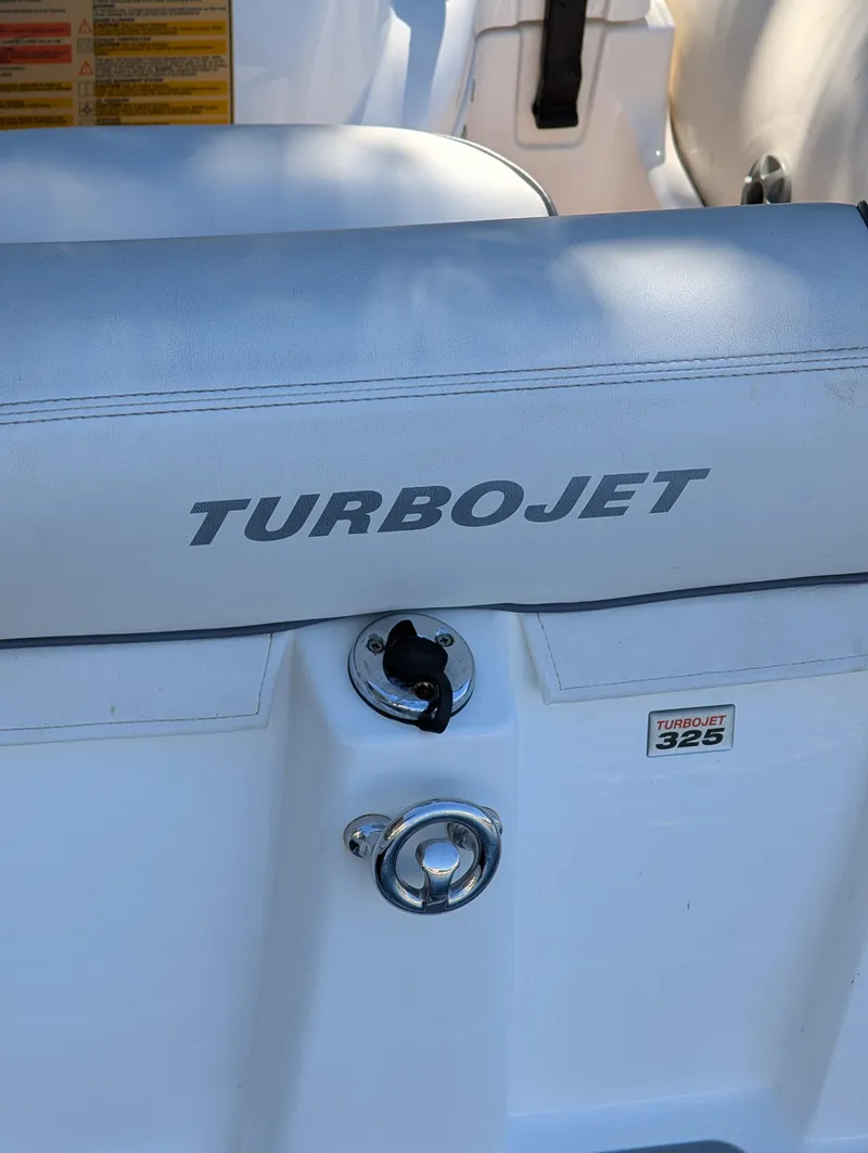 Slide: The Image of 2020 Williams Jet Tenders Turbojet 325, white seating with logo and ignition switch. - 14