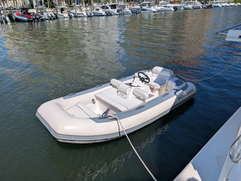 Slide: The Image of 2020 Williams Jet Tenders Turbojet 325 in marina, sleek design, white exterior. - 3