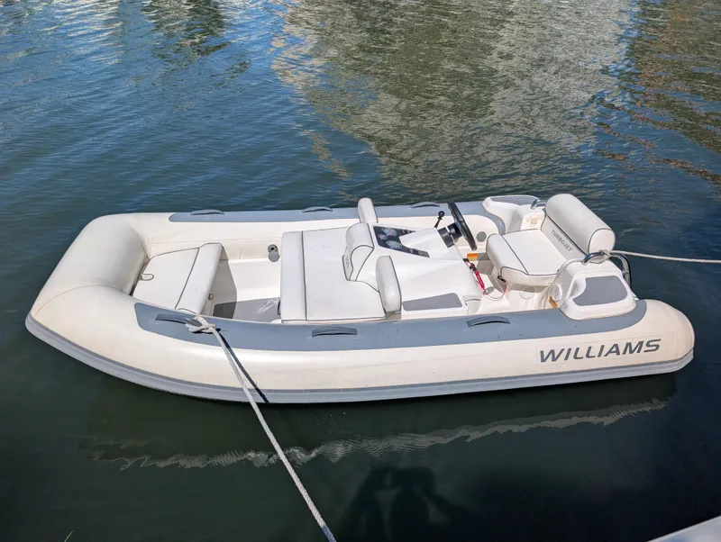 Slide: The Image of 2020 Williams Jet Tenders Turbojet 325, sleek white design, floating on calm water. - 5