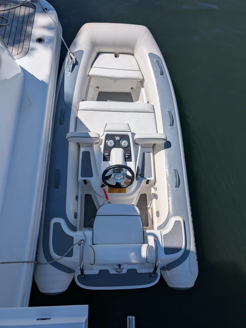 Slide: The Image of 2020 Williams Jet Tenders Turbojet 325 docked, top view, sleek white design. - 8