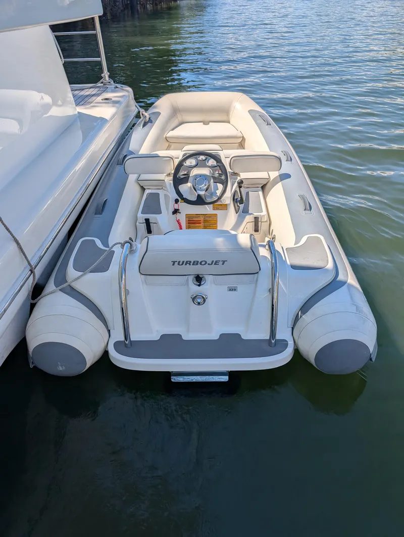 Slide: The Image of 2020 Williams Jet Tenders Turbojet 325 docked on calm water. - 9