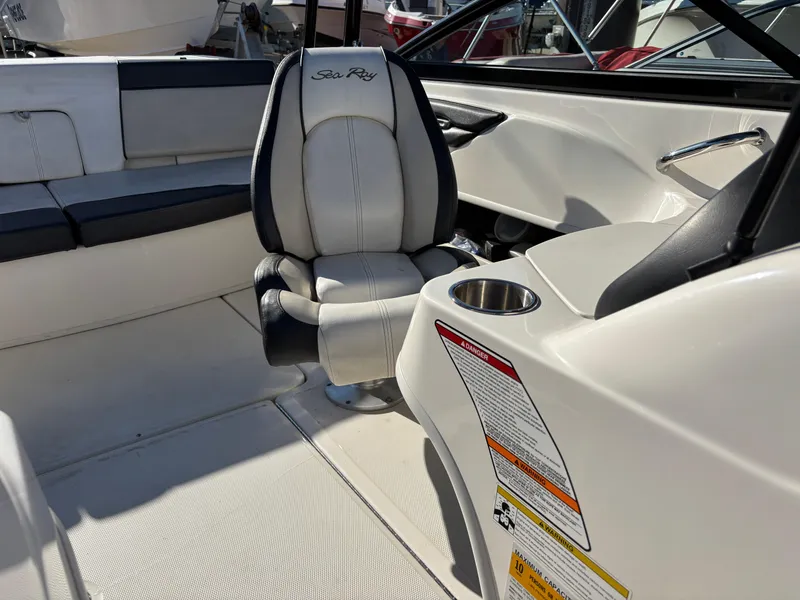 Slide: The Image of 2014 Sea Ray 205 Sport boat interior with captain's chair and cup holder. - 10