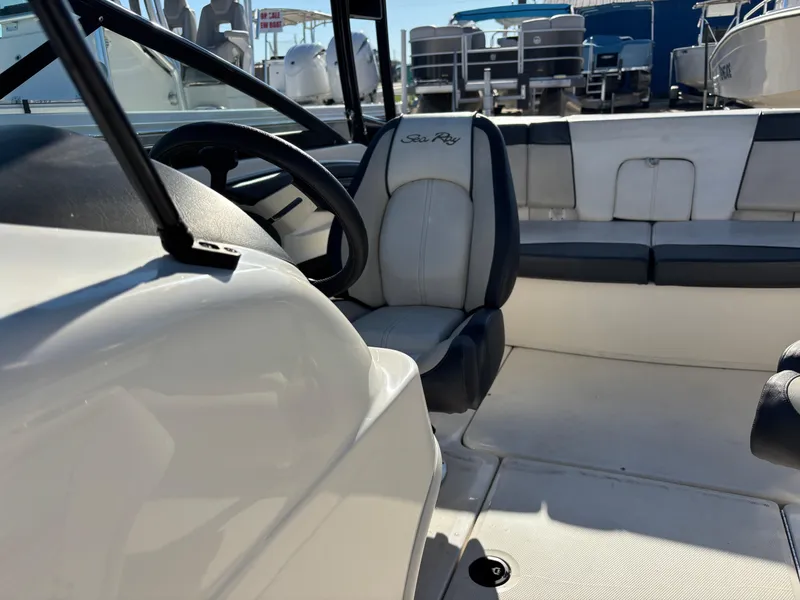 Slide: The Image of 2014 Sea Ray 205 Sport boat interior with steering wheel and seating. - 11