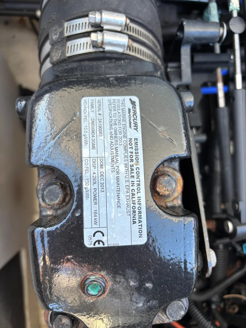 Slide: The Image of Close-up of a 2014 Sea Ray 205 Sport engine component with label details. - 12