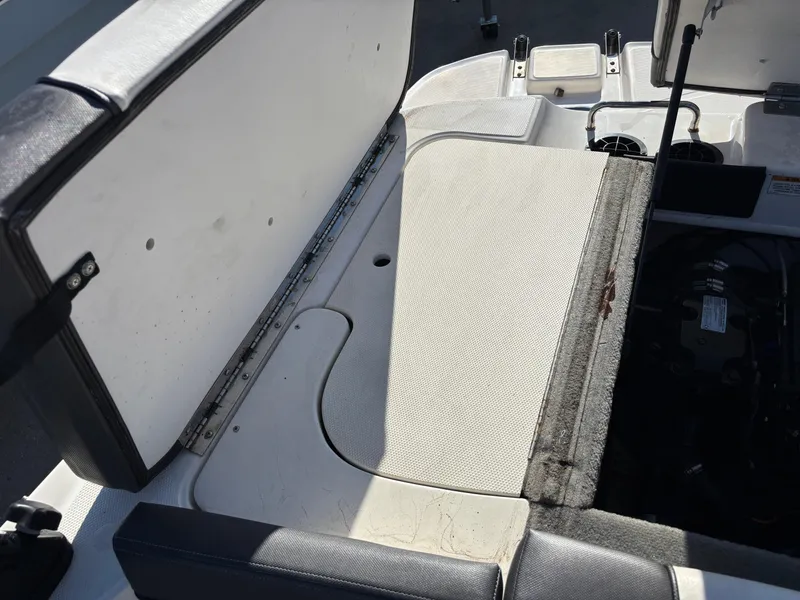 Slide: The Image of 2014 Sea Ray 205 Sport boat interior showing open storage compartment. - 14