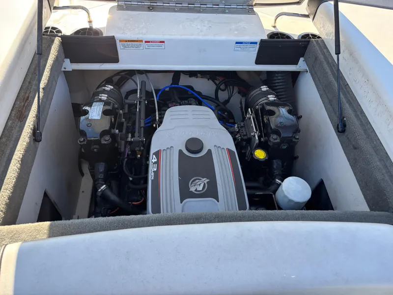 Slide: The Image of 2014 Sea Ray 205 Sport engine compartment with visible components and wiring. - 16