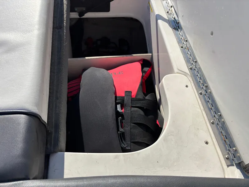 Slide: The Image of Storage compartment in a 2014 Sea Ray 205 Sport boat with life jackets. - 22
