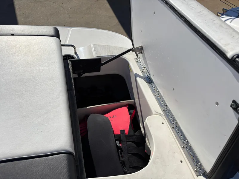 Slide: The Image of 2014 Sea Ray 205 Sport boat storage compartment with life jacket. - 23