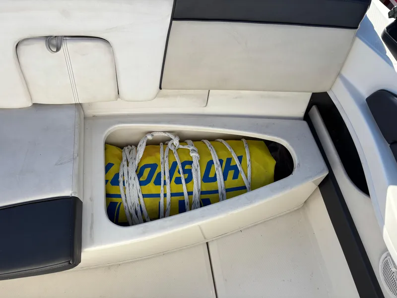 Slide: The Image of Storage compartment in a 2014 Sea Ray 205 Sport boat with a yellow inflatable. - 27