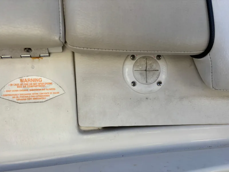 Slide: The Image of 2014 Sea Ray 205 Sport boat interior with warning label and seat detail. - 29