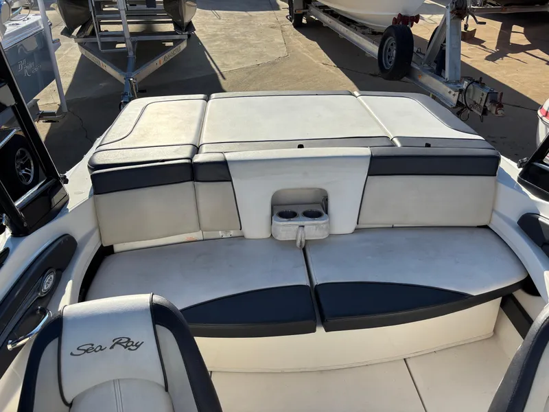 Slide: The Image of 2014 Sea Ray 205 Sport boat interior with cushioned seating and cup holders. - 32