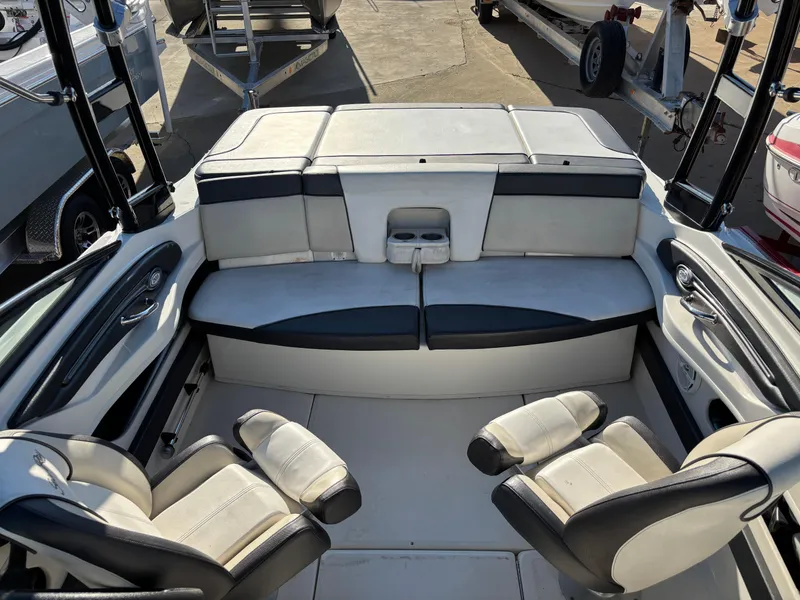 Slide: The Image of 2014 Sea Ray 205 Sport boat interior with seating and cup holders. - 33