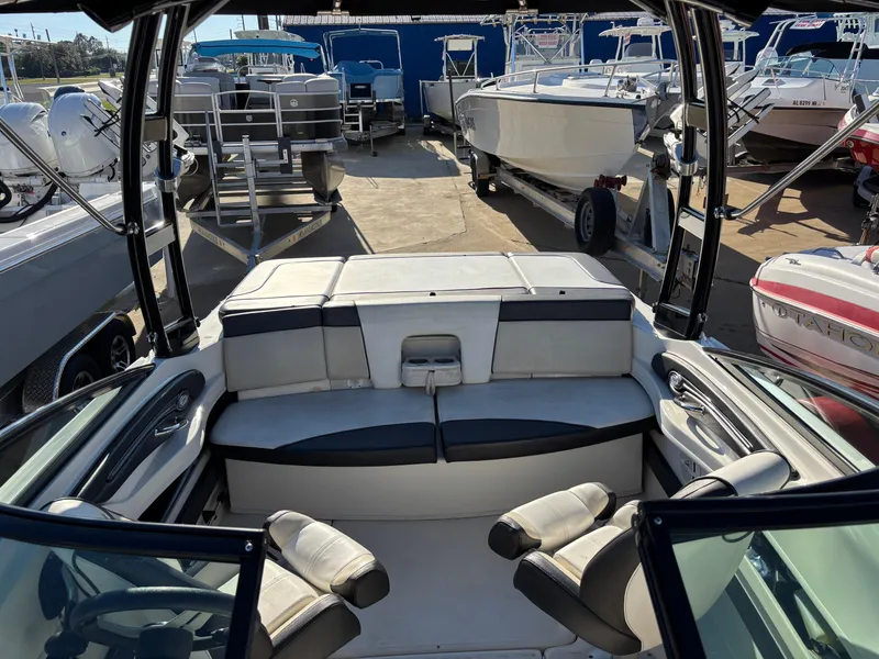 Slide: The Image of 2014 Sea Ray 205 Sport boat interior with seating, docked among other boats. - 34
