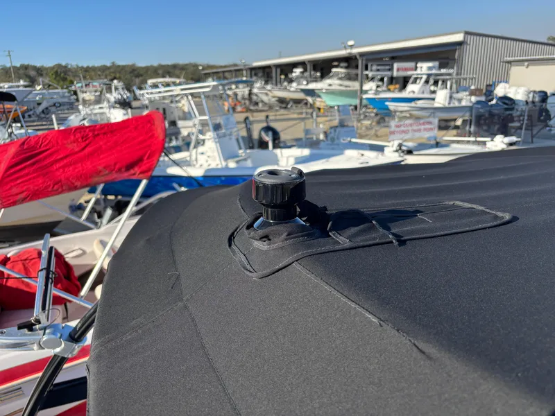 Slide: The Image of 2014 Sea Ray 205 Sport boat with cover in marina setting. - 39