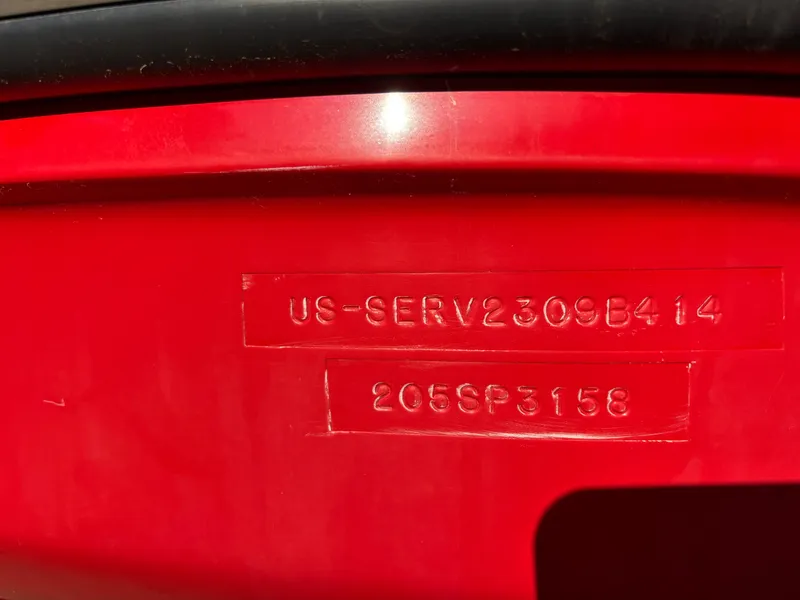 Slide: The Image of 2014 Sea Ray 205 Sport hull identification number on red surface. - 45