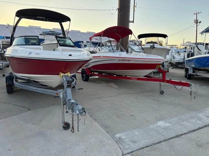 Slide: The Image of 2014 Sea Ray 205 Sport boats on trailers in a marina setting. - 47