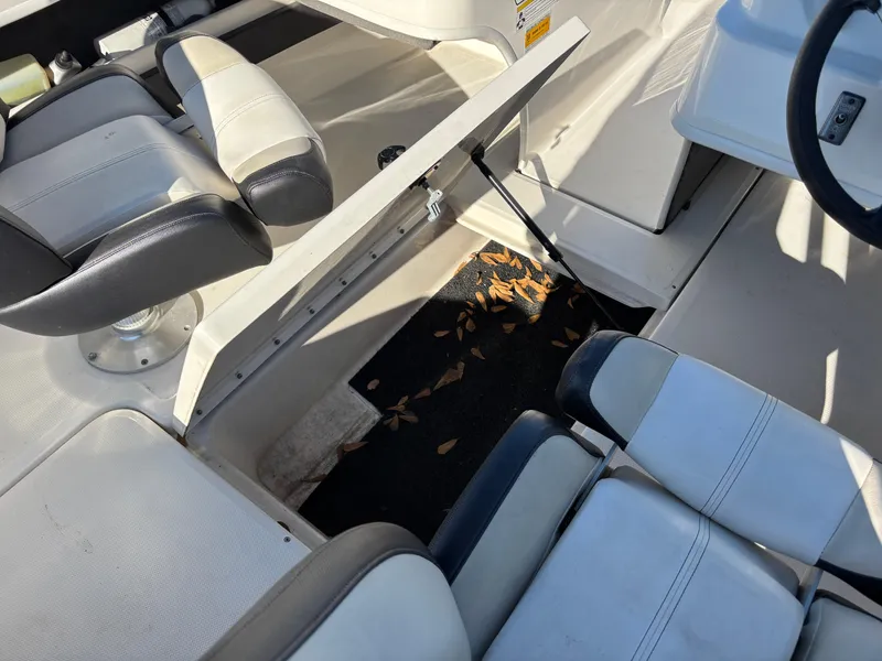 Slide: The Image of 2014 Sea Ray 205 Sport interior with open storage compartment and seating. - 5