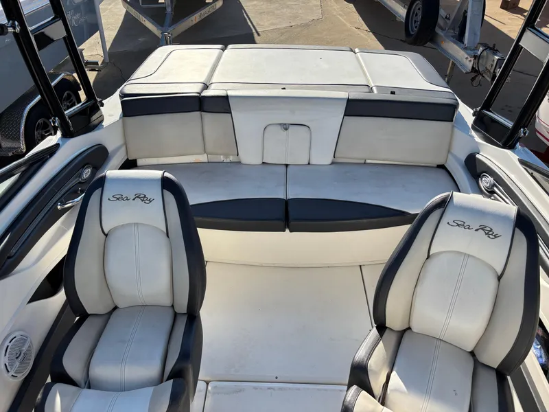 Slide: The Image of Interior of a 2014 Sea Ray 205 Sport boat with white seating. - 8