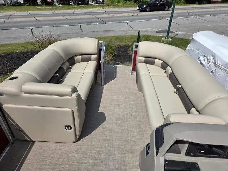 Slide: The Image of 2025 Sun Tracker PB 20 DLX pontoon boat interior with beige seating and open deck. - 3