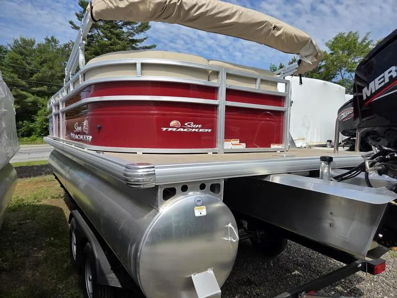 Slide: The Image of 2025 Sun Tracker PB 20 DLX pontoon boat with red exterior and covered canopy. - 8