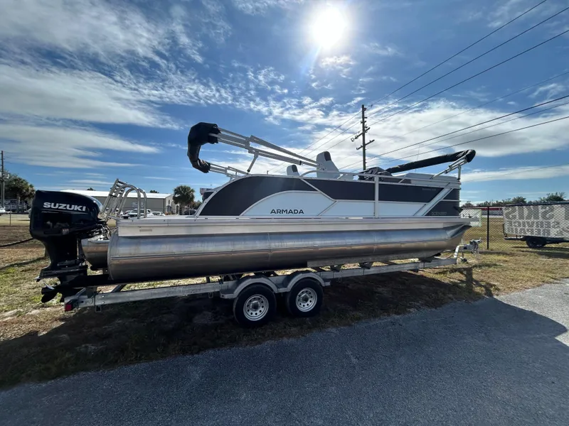 Slide: The Image of 2025 Armada Drakkar K-23SB 3T pontoon boat on trailer under sunny sky. - 15
