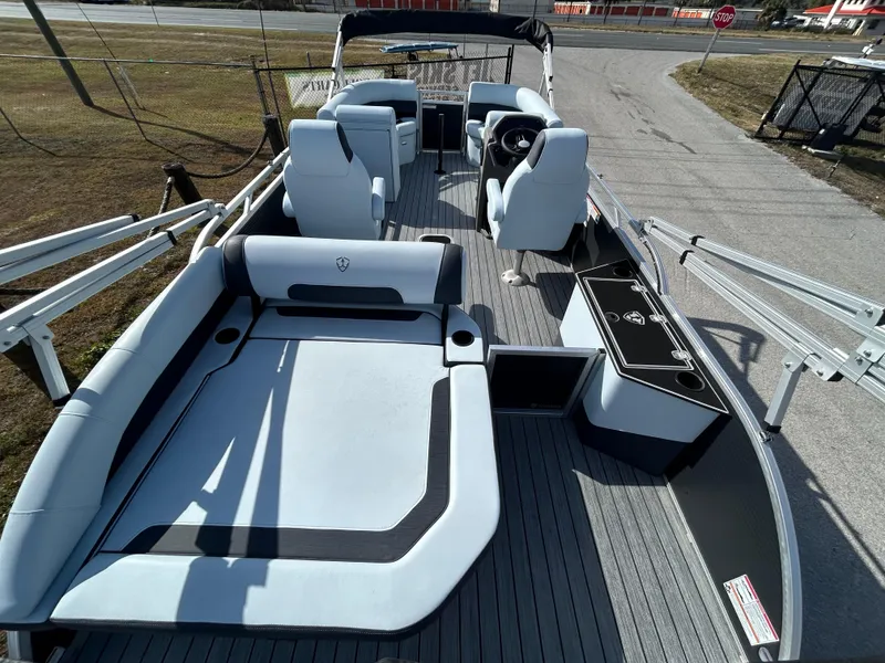 Slide: The Image of 2025 Armada Drakkar K-23SB 3T boat interior with seating and steering wheel. - 18