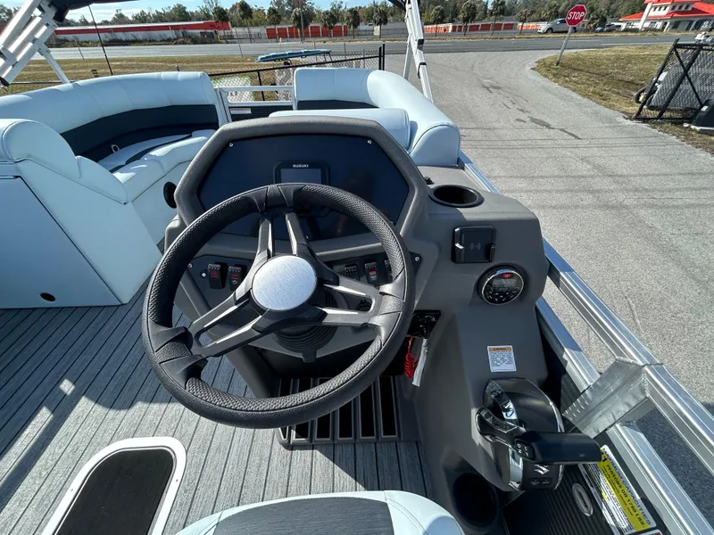 Slide: The Image of Cockpit of 2025 Armada Drakkar K-23SB 3T boat with steering wheel and seating. - 3