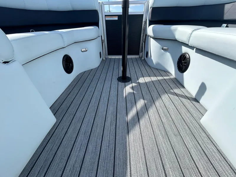 Slide: The Image of Interior view of 2025 Armada Drakkar K-23SB 3T boat with sleek seating and striped flooring. - 8