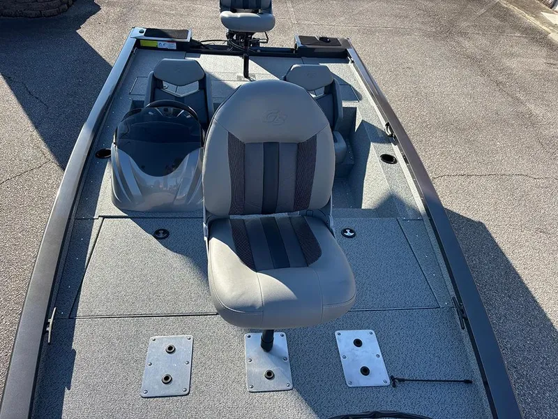 Slide: The Image of 2025 G3 Sportsman 1710 boat interior with gray seating and steering console. - 11